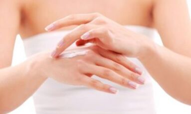 girl applying ointment to her hand